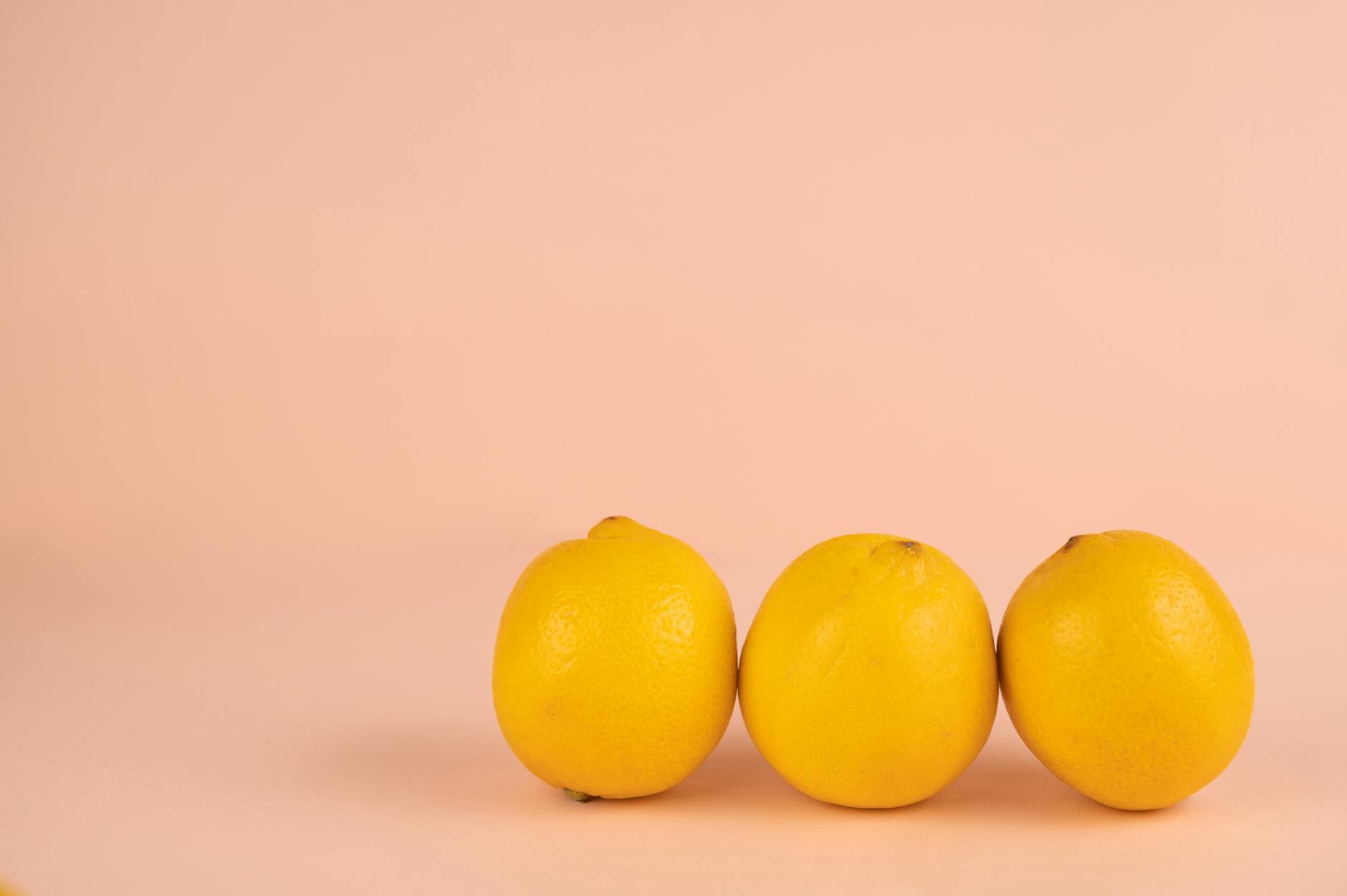 Two women smiling together with lemon slices, expressing openness and joy